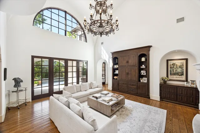 a living room with furniture and a chandelier