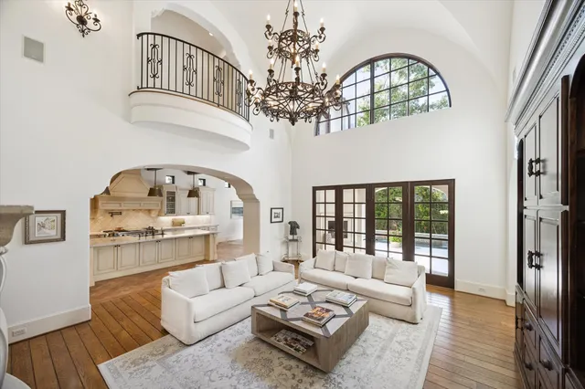 a living room with furniture a chandelier and a chandelier
