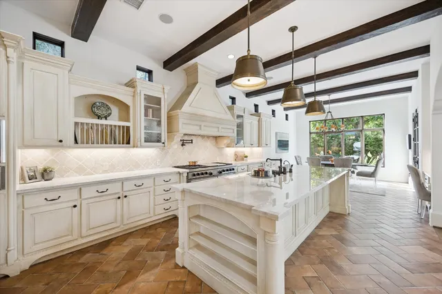 a kitchen with granite countertop a stove and a sink