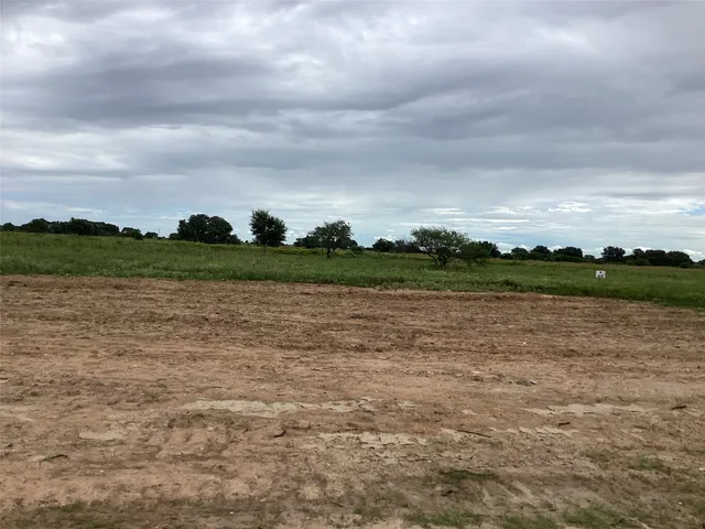 a view of a lake with houses in the back