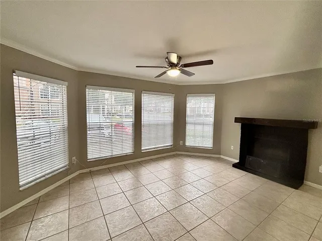 a view of an empty room with a fireplace and a window