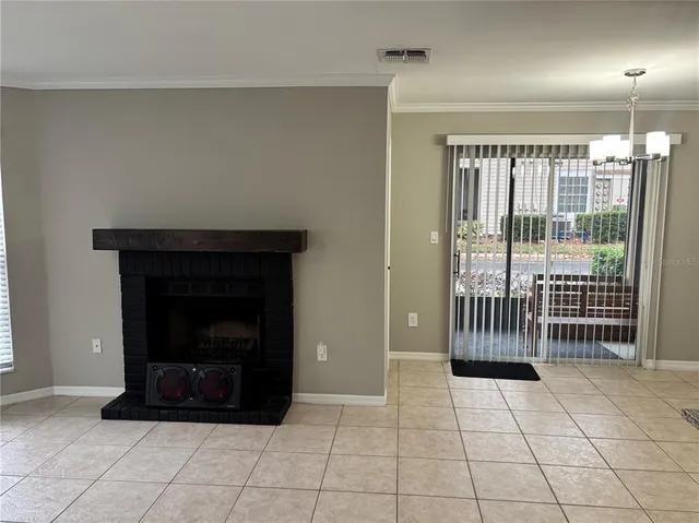 a view of a livingroom with a fireplace and window