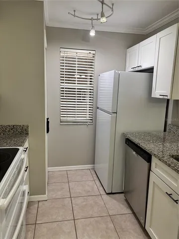 a kitchen with a refrigerator and a sink