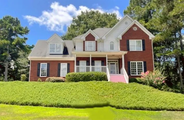 a front view of a house with a yard