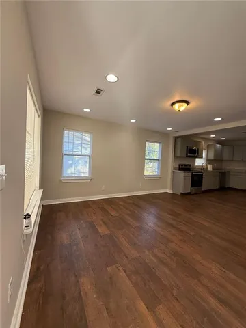 a large kitchen with stainless steel appliances granite countertop a large counter top a stove and a refrigerator