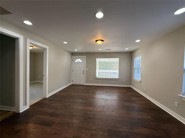 an empty room with a empty space and windows