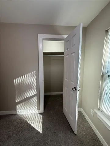 a kitchen with stainless steel appliances granite countertop a stove top oven a sink dishwasher and a refrigerator with wooden floor