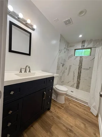 a view of kitchen with wooden floor and electronic appliances