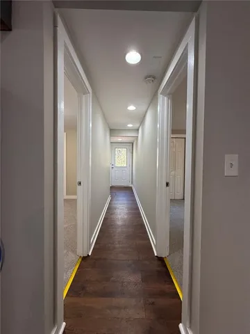 an empty room with windows and entrance