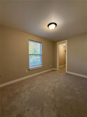 a view of a livingroom with wooden floor and a window