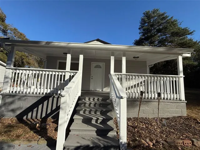 a view of a house with wooden fence