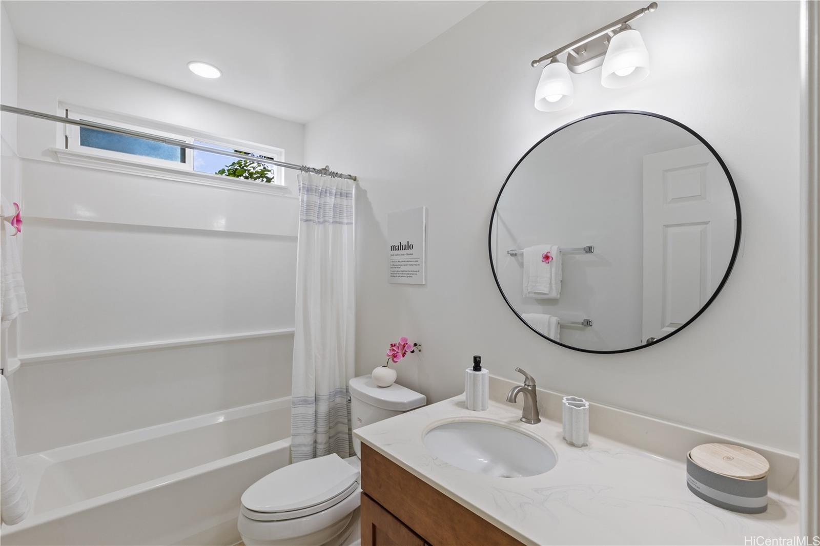 95-246 Wailawa Street Mililani, HI 96789 - Photo 12 of 14 a bathroom with a sink a toilet and a mirror