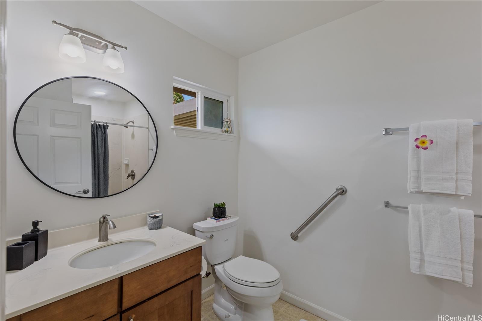95-246 Wailawa Street Mililani, HI 96789 - Photo 14 of 14 a bathroom with a toilet a sink and mirror