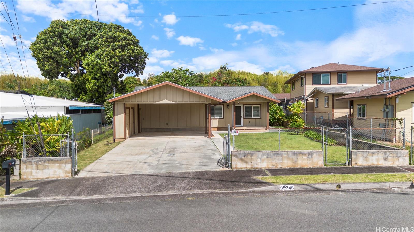 95-246 Wailawa Street Mililani, HI 96789 - Photo 6 of 14 a front view of a house with a yard and garage