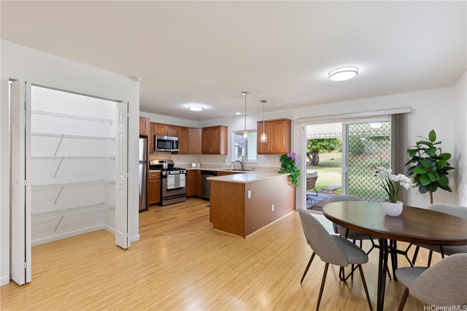 95-246 Wailawa Street Mililani, HI 96789 - Photo 8 of 14 a kitchen with a table and chairs in it