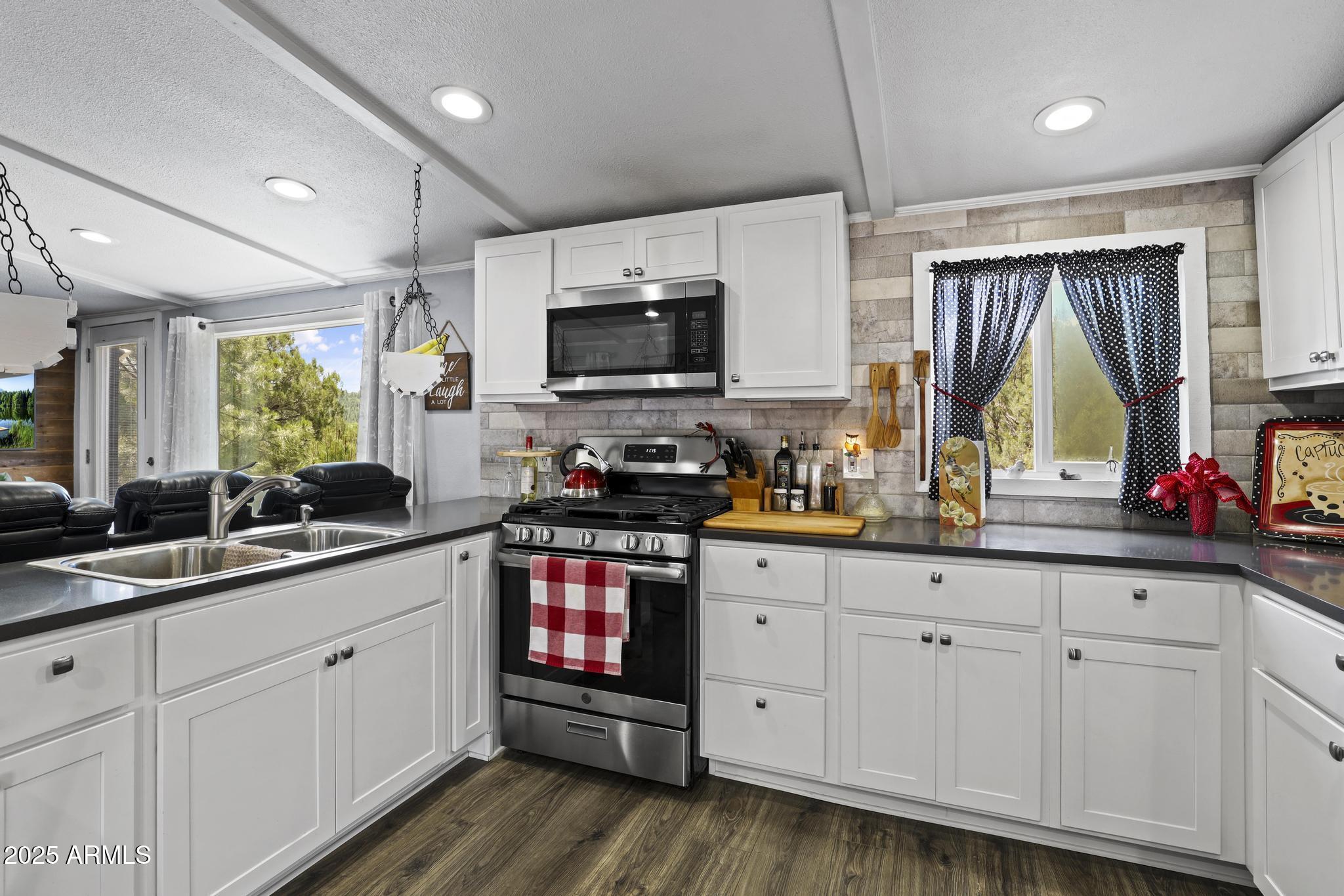 254 Blackfoot Road Payson, AZ 85541 - Photo 12 of 31 a kitchen with white cabinets and sink