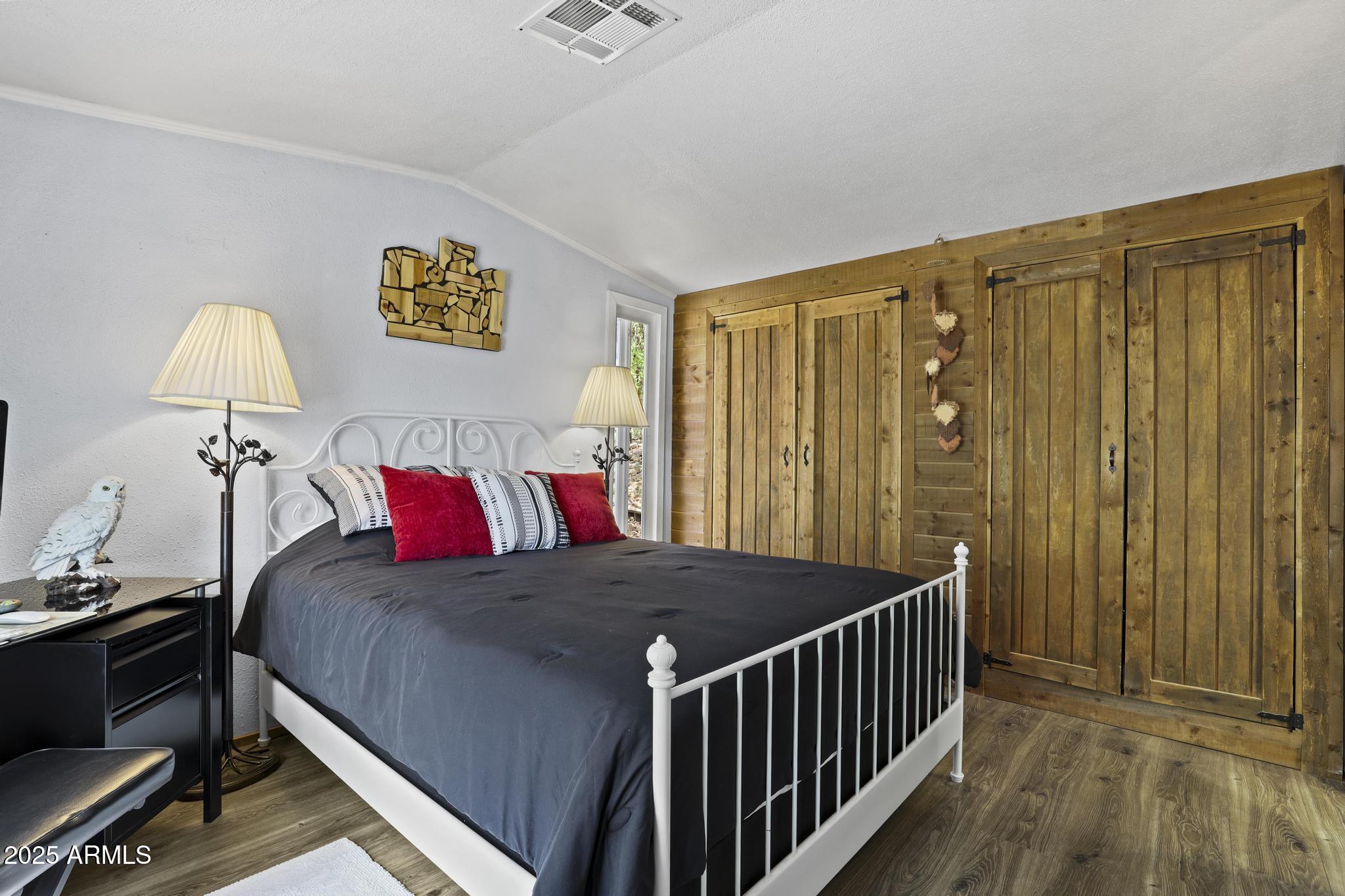 254 Blackfoot Road Payson, AZ 85541 - Photo 14 of 31 a bed sitting in a bedroom next to a wooden door