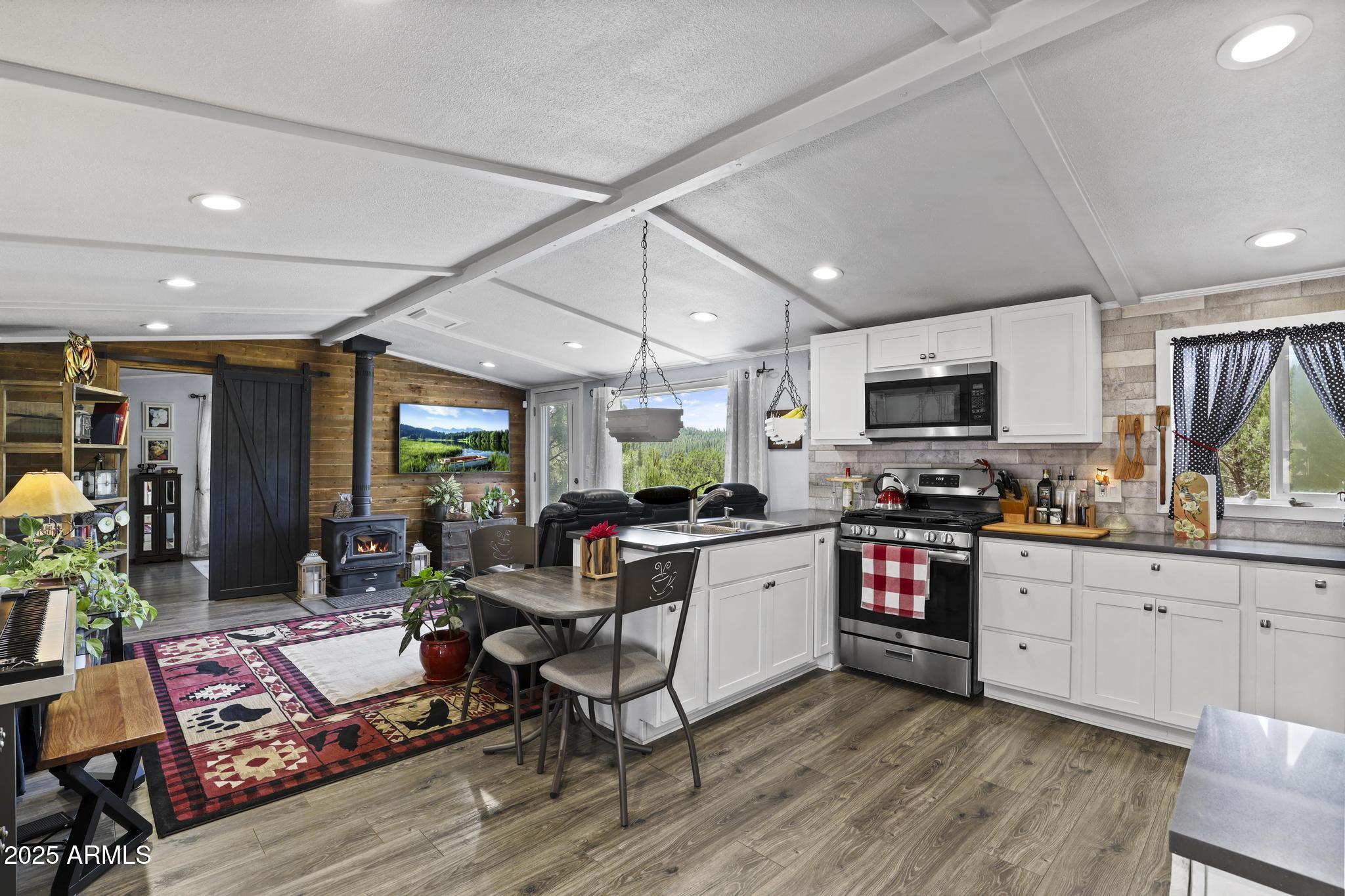254 Blackfoot Road Payson, AZ 85541 - Photo 10 of 31 a open kitchen with stainless steel appliances granite countertop a stove and cabinets