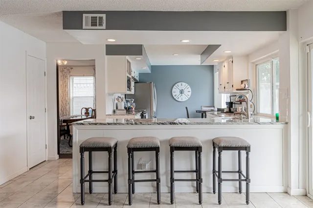 a kitchen with a table and chairs in it