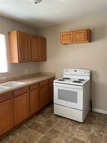 a kitchen with a stove and a sink