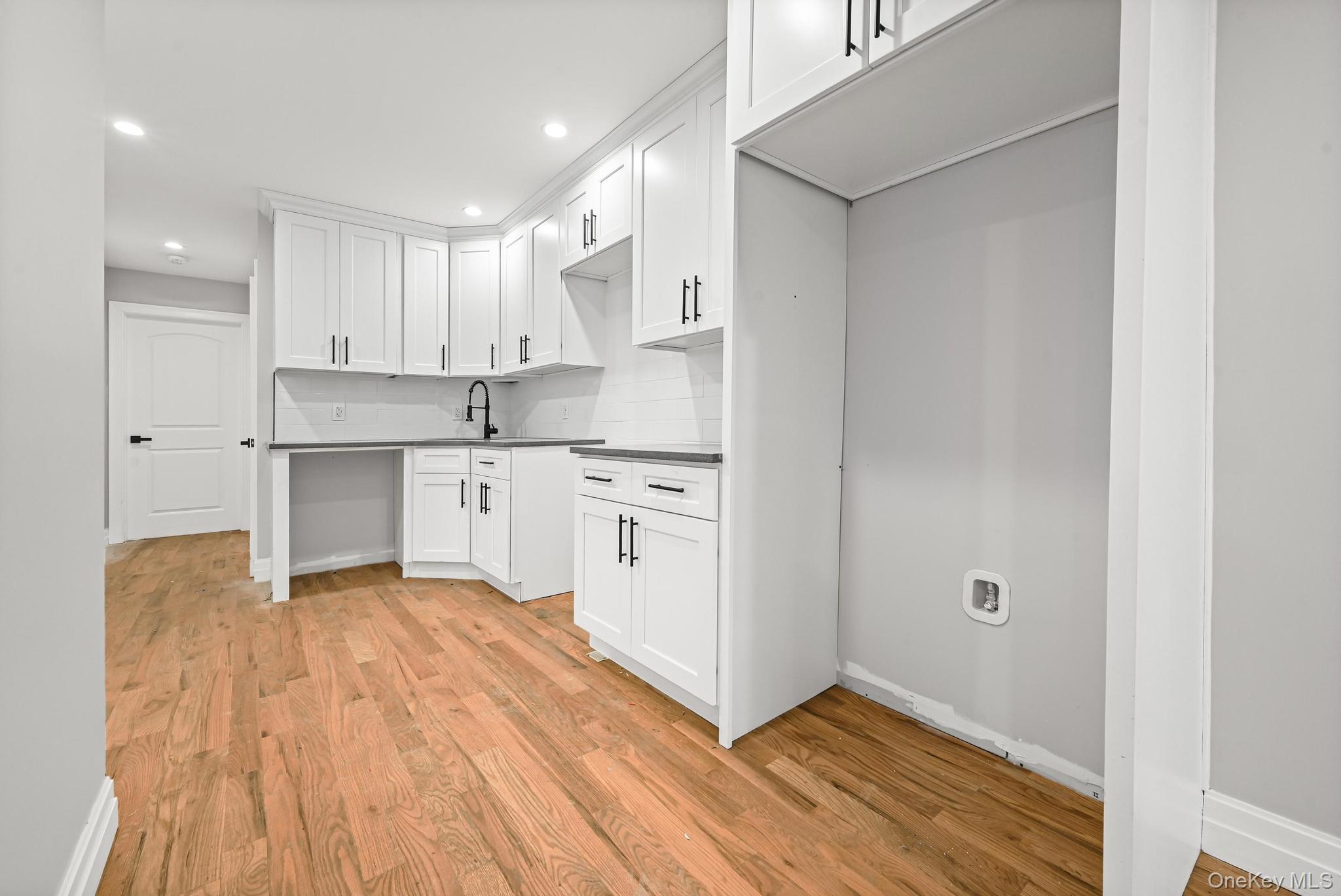 160-15 118th Road Queens, NY 11434 - Photo 11 of 23 a view of a kitchen with white cabinets