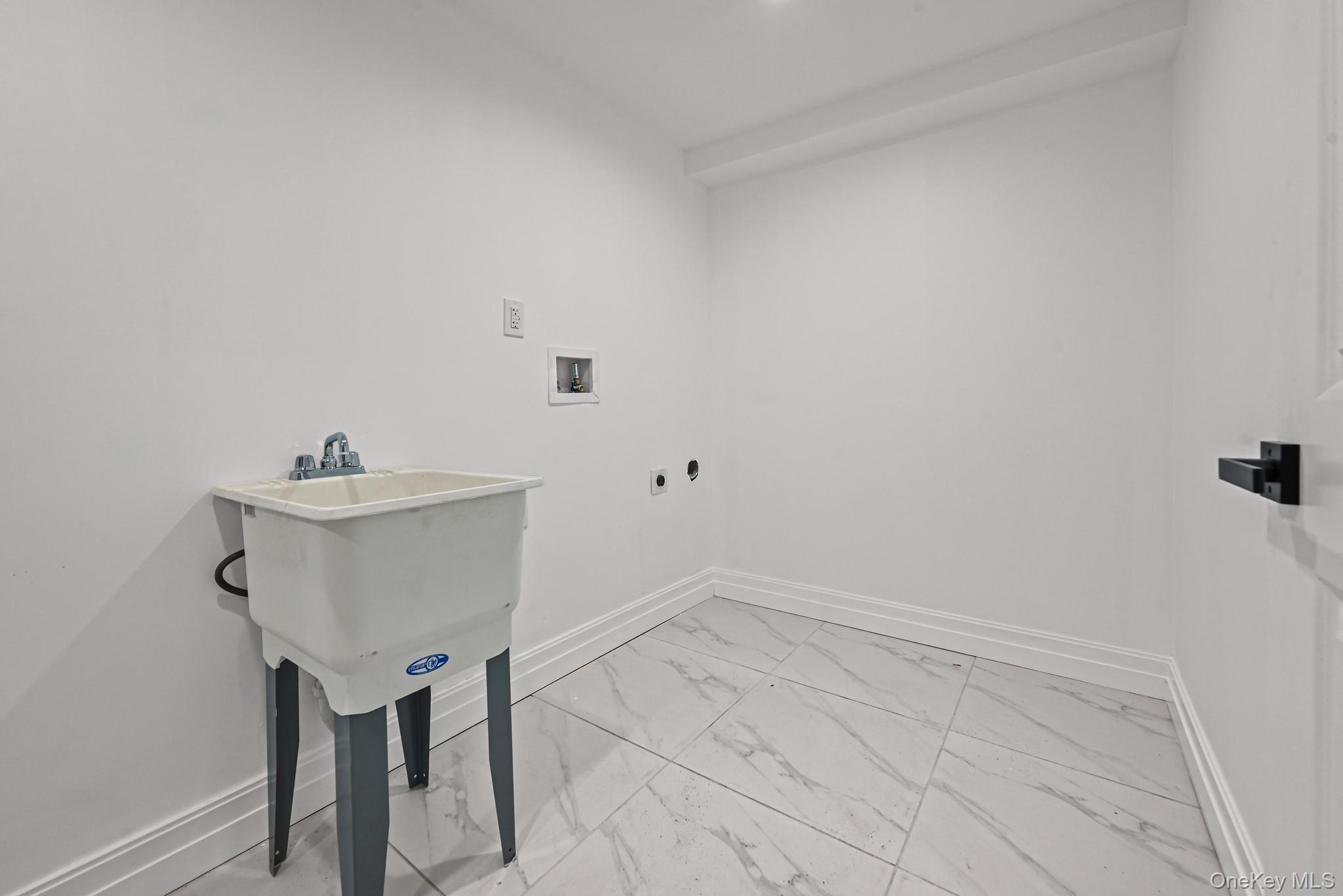 160-15 118th Road Queens, NY 11434 - Photo 19 of 23 a bathroom with a sink and a mirror