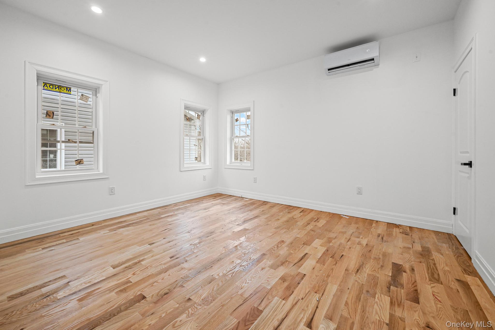160-15 118th Road Queens, NY 11434 - Photo 8 of 23 a view of empty room with wooden floor and fan