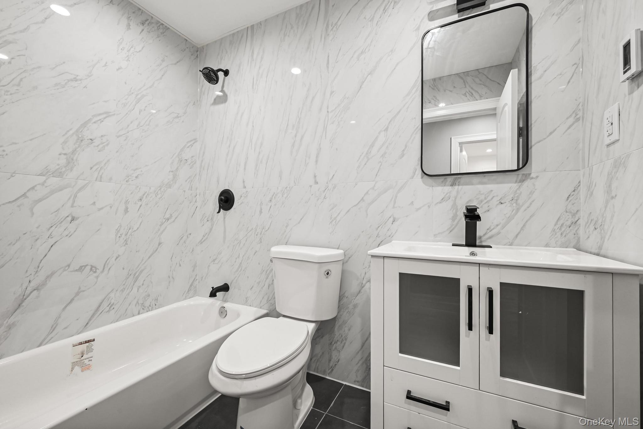 160-15 118th Road Queens, NY 11434 - Photo 9 of 23 a bathroom with a sink toilet and shower