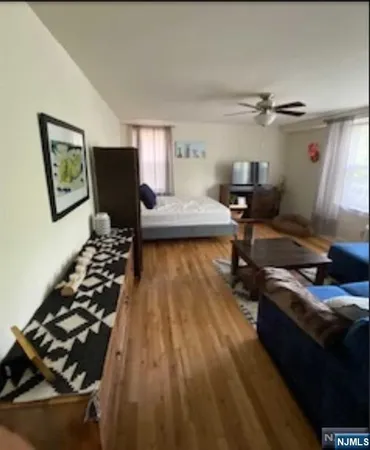 a bedroom with furniture and a rug