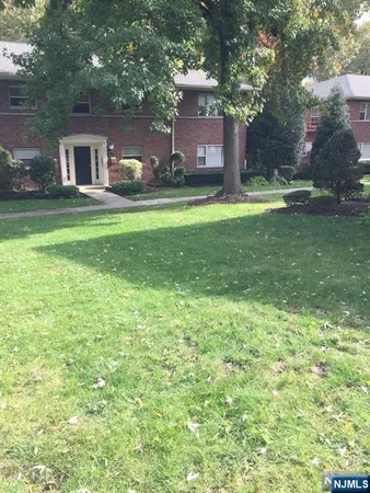a house view with swimming pool in front of it