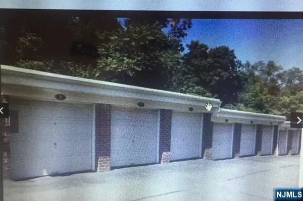 a view of a house with a yard and potted plants
