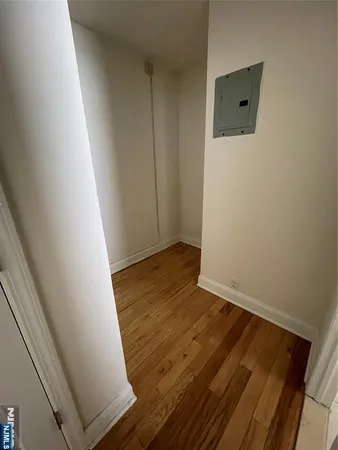 a view of a room with wooden floor