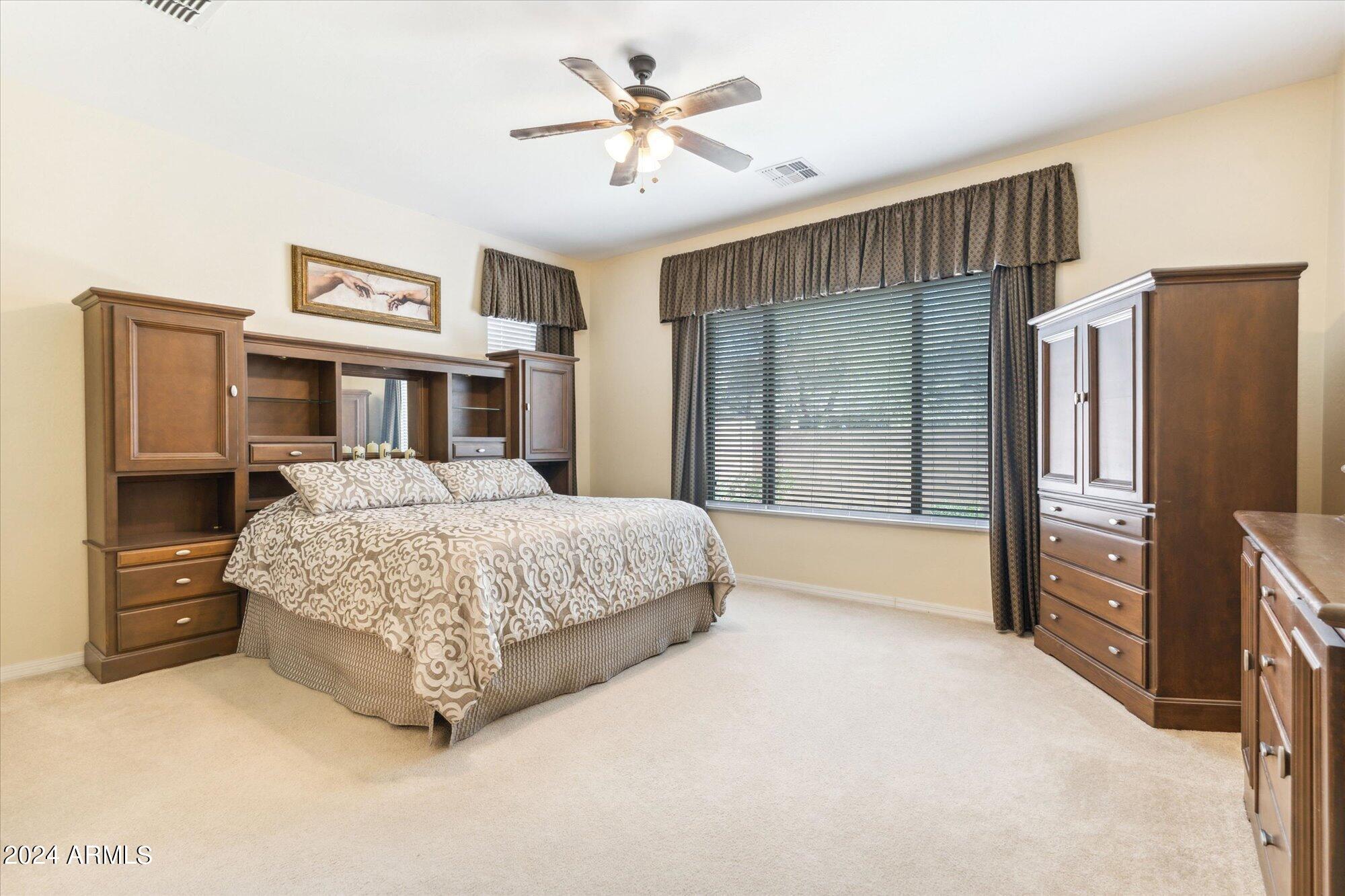 3307 North Riverside Drive Florence, AZ 85132 - Photo 12 of 35 a bedroom with a bed dresser and a large window