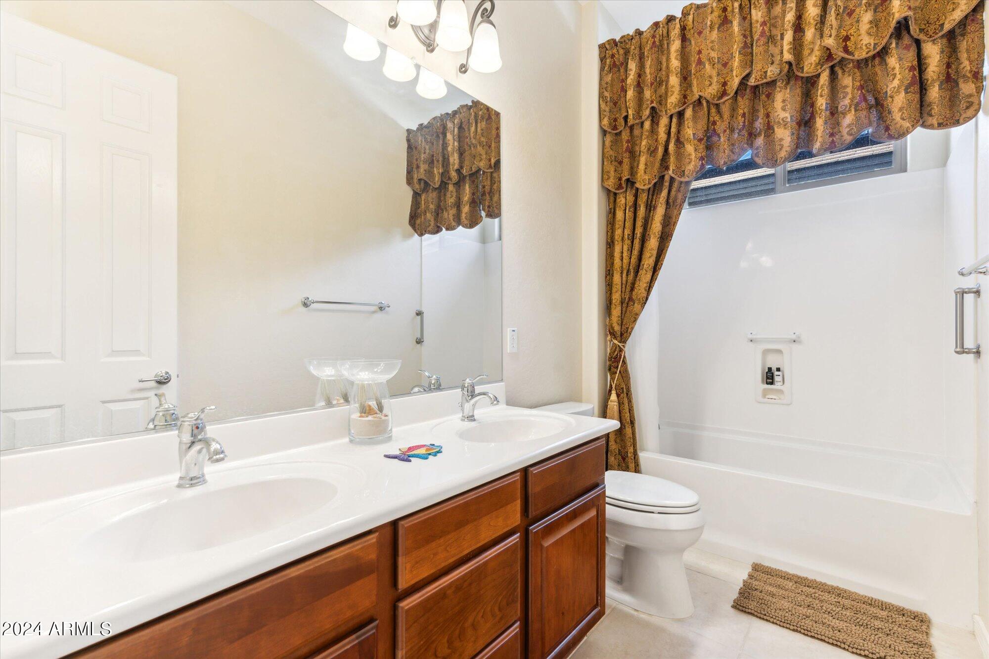 3307 North Riverside Drive Florence, AZ 85132 - Photo 18 of 35 a bathroom with a sink a toilet and shower