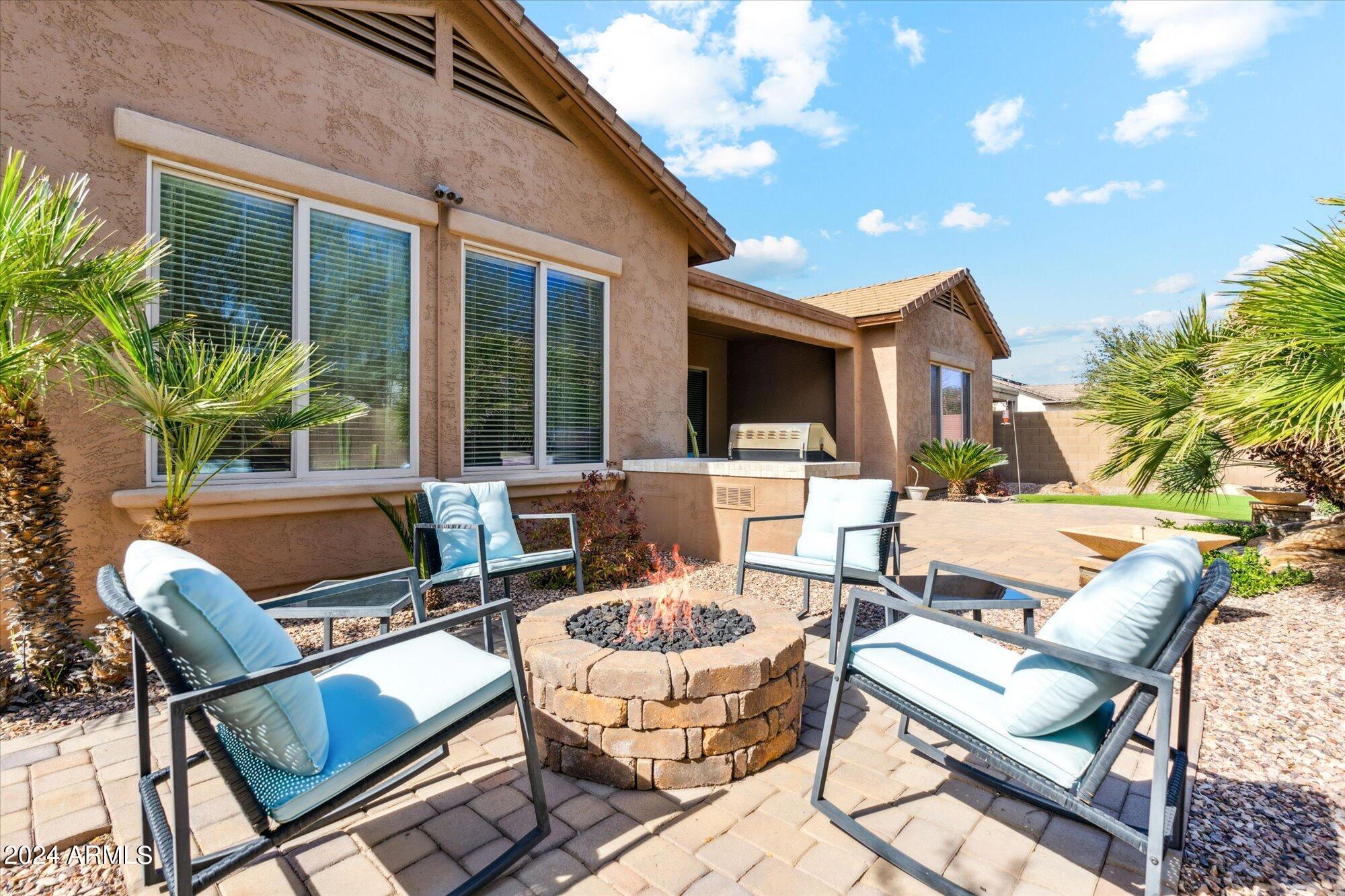3307 North Riverside Drive Florence, AZ 85132 - Photo 4 of 35 a view of a patio with a dining table and chairs with wooden floor