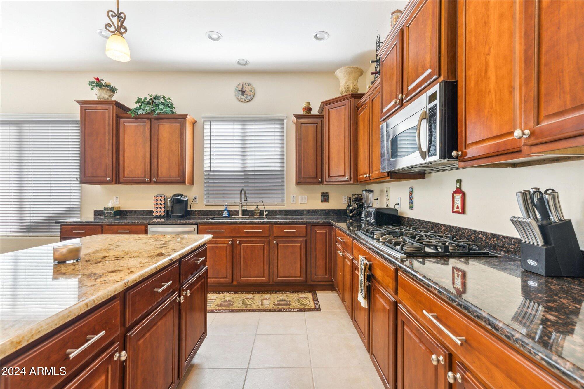 3307 North Riverside Drive Florence, AZ 85132 - Photo 6 of 35 a kitchen with stainless steel appliances granite countertop a stove sink and cabinets