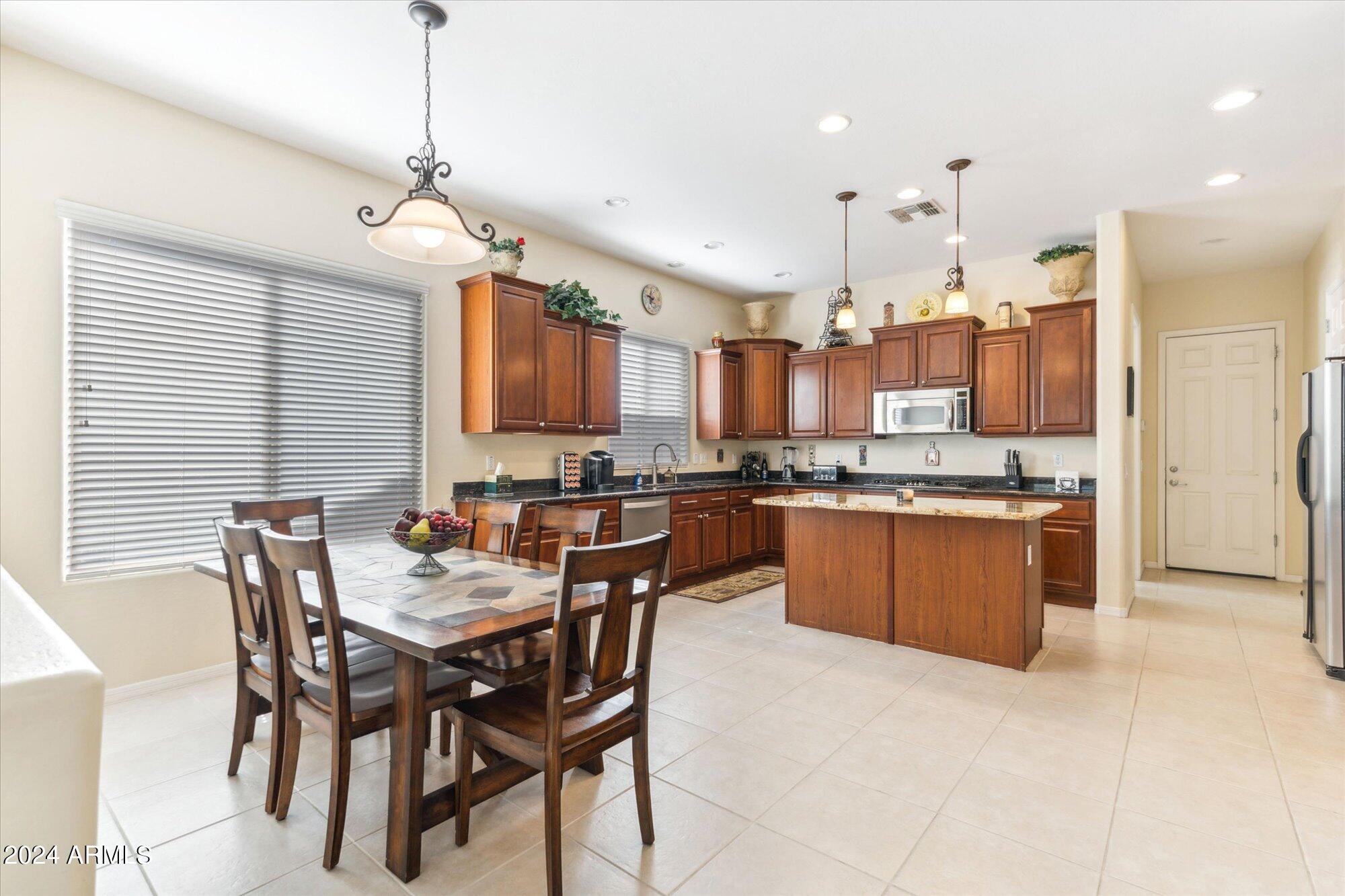 3307 North Riverside Drive Florence, AZ 85132 - Photo 7 of 35 a large kitchen with a table and chairs