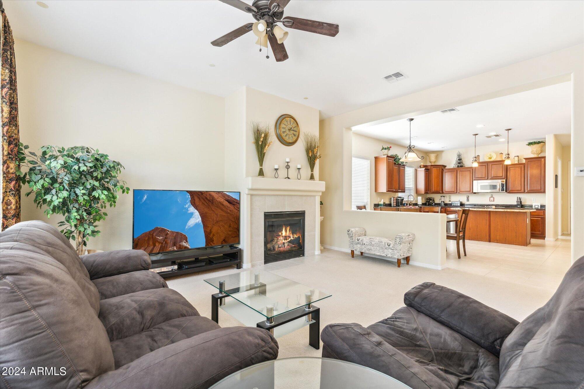 3307 North Riverside Drive Florence, AZ 85132 - Photo 8 of 35 a living room with furniture and a fireplace
