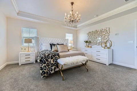 a bedroom with a bed and a chandelier