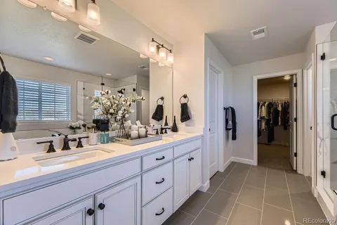 a bathroom with double sink and a mirror