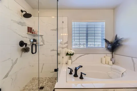 a bathroom with a bathtub and a shower