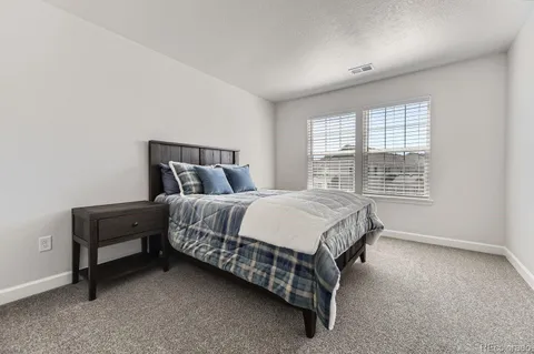 a bed sitting in a bedroom next to a window