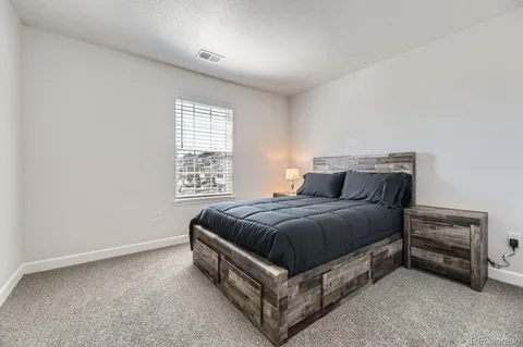 a bed sitting in a bedroom next to a window