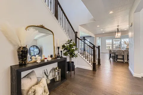 a view of a hallway with entryway wooden floor and furniture