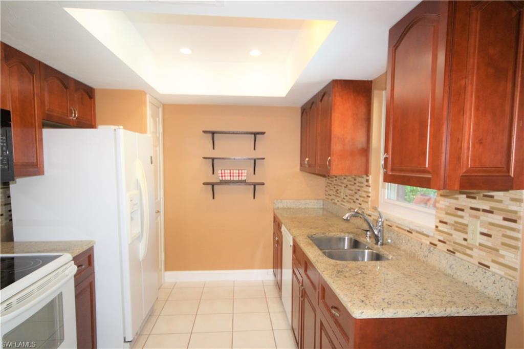 4553 30th Place Southwest Naples, FL 34116 - Photo 6 of 19 Tidy Low-maintenance Kitchen has Perfect View