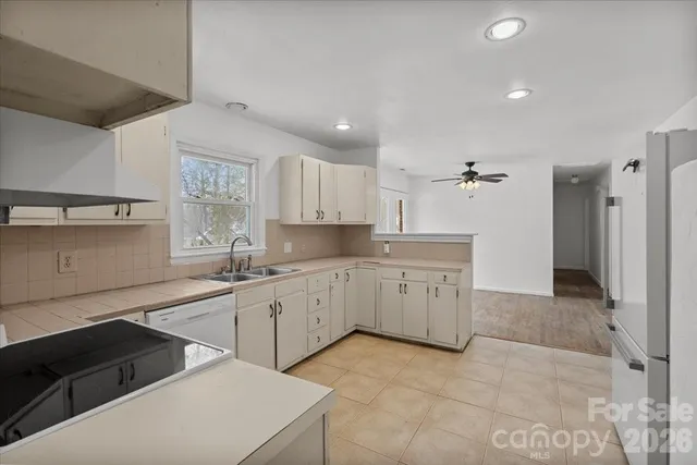 a kitchen with a sink stove and cabinets