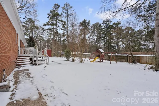 a view of a park with snow on the road