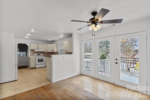 a view of a kitchen with a sink and dishwasher a refrigerator with wooden floor