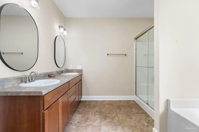 a bathroom with a double vanity sink and a mirror