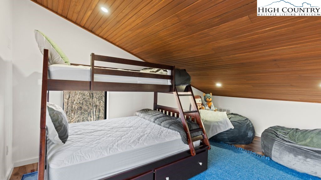 114 Windridge Road Beech Mountain, NC 28604 - Photo 12 of 49 a bedroom with a bed and lamp